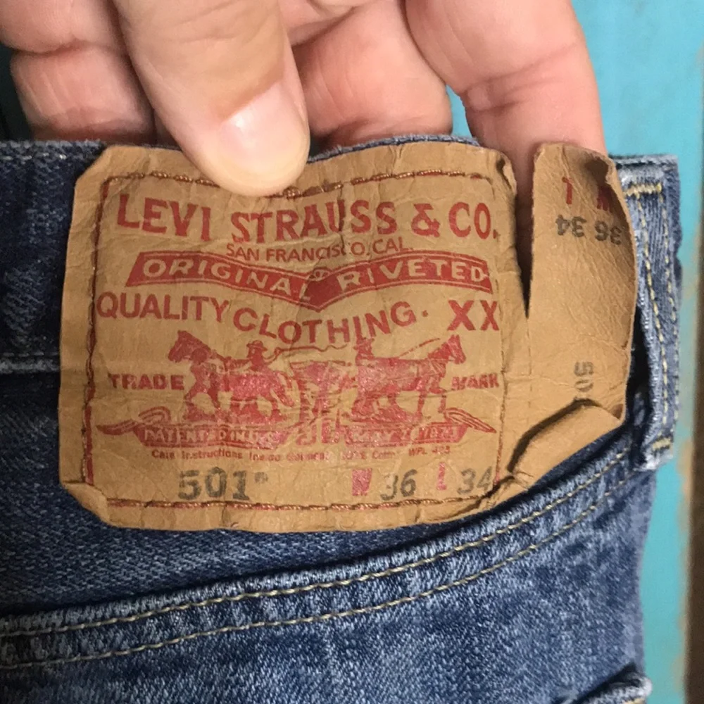 Levi’s 501 button fly Jeans size 35x28 (tag size 36x34) lightly distressed